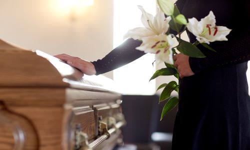 Woman in Front of a Casket 